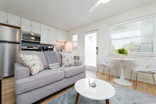 a living room with a couch and a table at Be A Nomad - Beachside Apartments in Jacksonville Beach