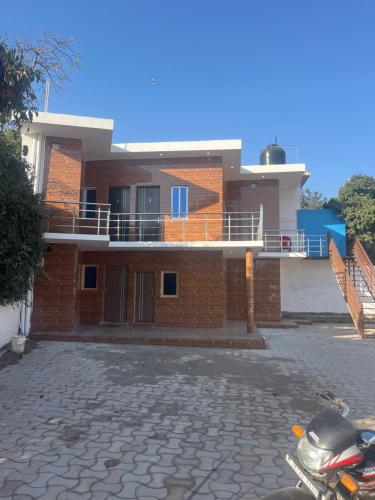 a house with a motorcycle parked in front of it at KDN PALACE in Udhampur