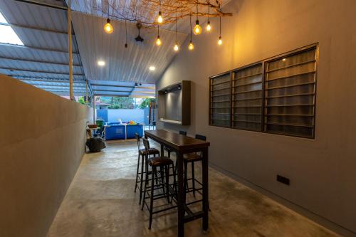 a room with a bar with a table and a tv at 5R4B 15Pax V KTV,KID'S POOL,POOL TABLE NEAR USM,LWE HOSPITAL,SPI ARENA in George Town