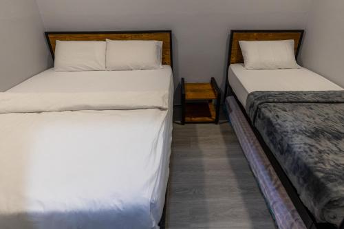 two beds sitting next to each other in a room at 5R4B 15Pax V KTV,KID'S POOL,POOL TABLE NEAR USM,LWE HOSPITAL,SPI ARENA in George Town