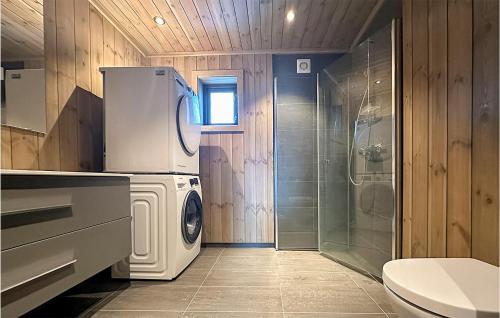 ein Badezimmer mit einer Waschmaschine und einem Trockner neben einer Dusche in der Unterkunft Nice Home In Hornindal With Kitchen in Hornindal