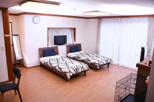 Postel nebo postele na pokoji v ubytování HAKONE LEON