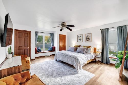 um quarto com uma cama e uma ventoinha de tecto em CR East River House em De Pere
