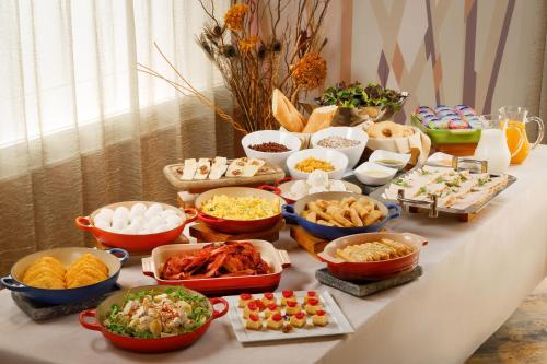 a table with many different types of food on it at The Luxe Manor in Hong Kong
