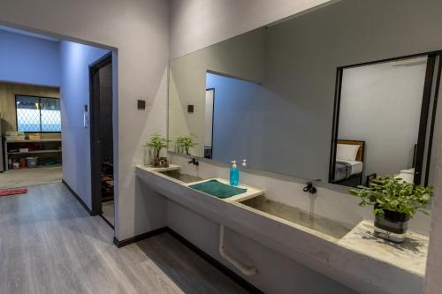 a bathroom with a sink and a large mirror at -NEW- 22Pax 5R4B V KTV,KID'S POOL,POOL TABLE NEAR USM,LWE HOSPITAL,SPI ARENA in George Town
