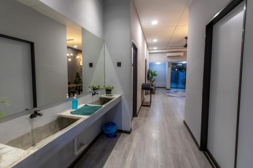 a bathroom with two sinks and a large mirror at -NEW- 22Pax 5R4B V KTV,KID'S POOL,POOL TABLE NEAR USM,LWE HOSPITAL,SPI ARENA in George Town