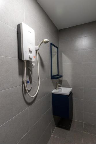 a bathroom with a shower with a sink and a mirror at -NEW- 22Pax 5R4B V KTV,KID'S POOL,POOL TABLE NEAR USM,LWE HOSPITAL,SPI ARENA in George Town