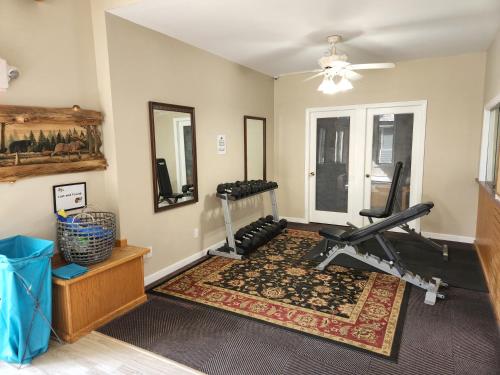 a room with a gym with a treadmill and a treadmill at White Mountains Getaway with amazing views! in Bartlett