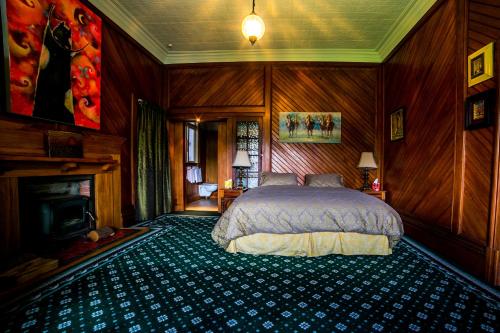 a bedroom with a bed and a fireplace at Shady Rest Bed & Breakfast in Takaka