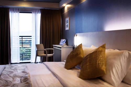 En eller flere senger på et rom på Pillows Hotel Cebu