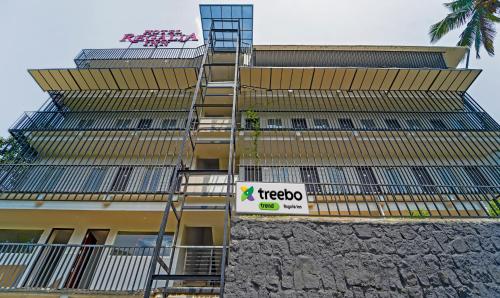 un edificio con una escalera de incendios a un lado. en Treebo Trend Regalia Inn Civil Station en Kalpetta