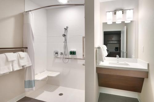 a white bathroom with a sink and a shower at TownePlace Suites by Marriott Salt Lake City Downtown in Salt Lake City