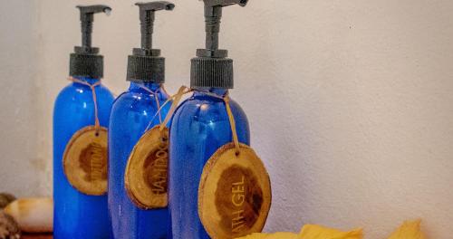a group of three blue bottles with wooden spoons at Navutu Stars Resort in Matayalevu