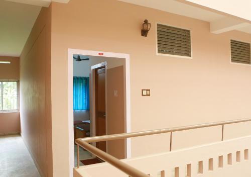 a staircase in a house with a stair railing at Chakalakkal Residency in Sultan Bathery