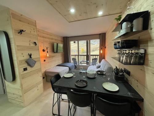 une salle à manger avec une table et des chaises dans une pièce dans l'établissement f2 28 m2 n°405 5 personnes ski au pied/piscine, à Valmeinier