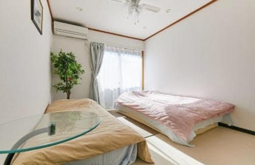 Giường trong phòng chung tại SHIBUYA HOUSE