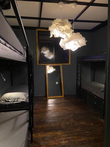 a room with two bunk beds and a chandelier at Bibhitaki Hostels Palolem Beach in Palolem