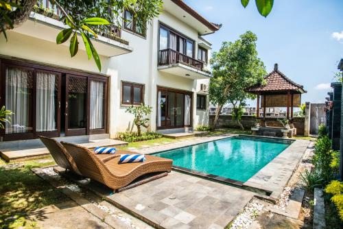 a swimming pool in the backyard of a house at Azure House - the dive to bright holiday in Ubud