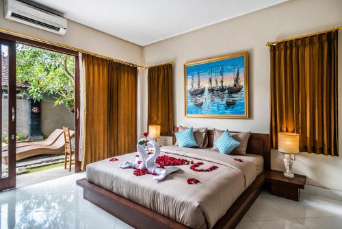 a bedroom with a bed with two swans on it at Azure House - the dive to bright holiday in Ubud