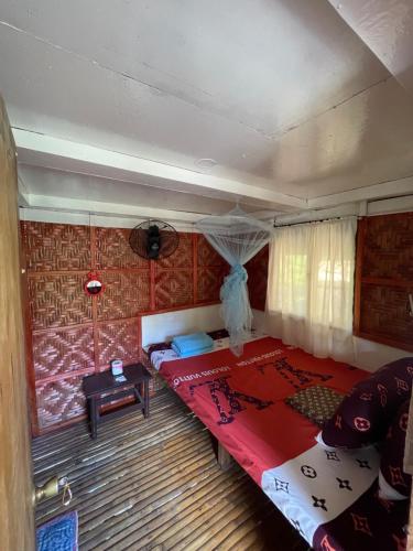 a bedroom with a large red bed in a room at Fely's Homestay in Batuan