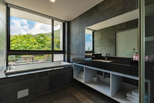 a bathroom with a sink and a large mirror at Ocean Paradise in Yanliau