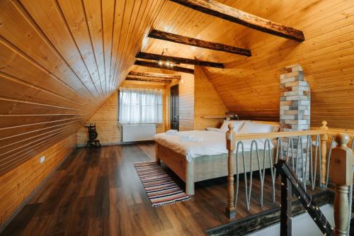 ein Schlafzimmer mit einem Bett in einer Holzdecke in der Unterkunft Little Bear Lodge in Sibiu