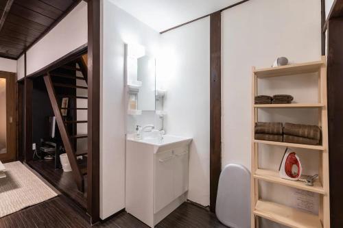 a bathroom with a sink and a toilet in a room at Yagara Terrace House A in Osaka