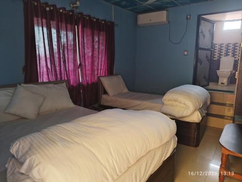 Ένα ή περισσότερα κρεβάτια σε δωμάτιο στο Rose Guest House