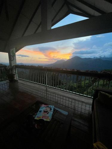 a balcony with a view of a sunset at Awesome Place in Ella