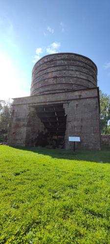 a large brick building in a field of grass at Gamla Badhuset in Borgvik