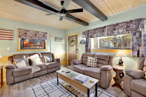 a living room with two couches and a table at 2387- Hidden Loft Chalet cabin in Big Bear City