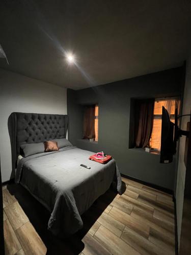 a bedroom with a bed and two windows at Apartamento G4 in Guatemala