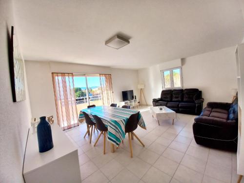 un salon avec une table et un canapé dans l'établissement Appartement T4 92M2 pour 6 pers à 400m de la plage, à Fréjus
