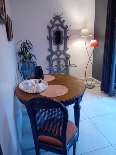 a table with two chairs and a plate on it at coté remparts in Provins