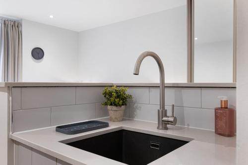 a kitchen with a sink and a faucet at Rock Mill Apt 3 with Terrace in Stony Middleton