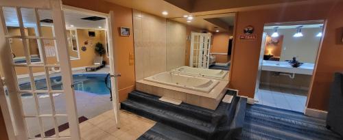 a large bathroom with a tub and a sink at Inn of the Dove - Romantic Luxury Suites with Jacuzzi & Seasonal Fireplace at Harrisburg-Hershey-Philadelphia, PA in Harrisburg