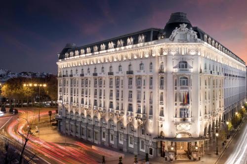 ein großes weißes Gebäude in der Nacht mit Verkehr in der Unterkunft The Westin Palace, Madrid in Madrid