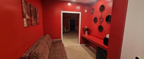 a red living room with a red wall at Inn of the Dove - Romantic Luxury Suites with Jacuzzi & Seasonal Fireplace at Harrisburg-Hershey-Philadelphia, PA in Harrisburg