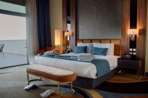 a bedroom with a large bed and a large window at Tolip Resort El Galala Hills in Ain Sokhna