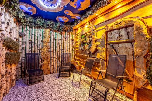 a room with chairs and a wall with a mural at Konopka Forest Home & SPA in Bukovel