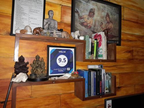 a shelf with books and other items on it at Villa Ali in Galle
