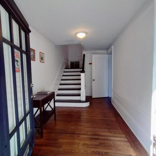 a hallway with a staircase and a stair case at Sunny SF home - cozy, spacious, convenient w/parking, A+ location!! in San Francisco