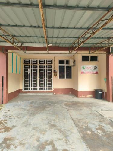 an empty parking lot in a building with a garage at Wafiy Homestay in Machang