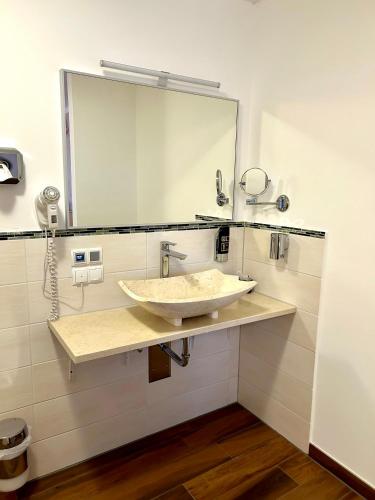 a bathroom with a sink and a large mirror at Waldgasthof Im Schwall in Nastätten