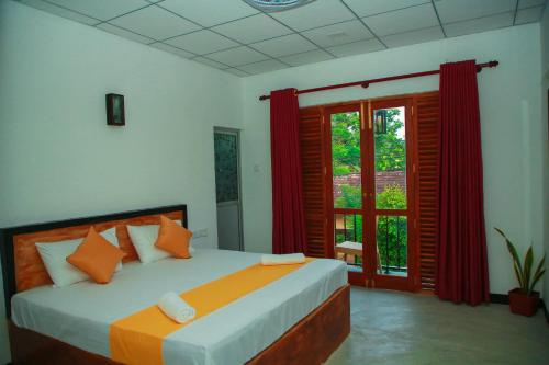 a bedroom with a bed and a large window at Samee Dream Guest in Midigama East