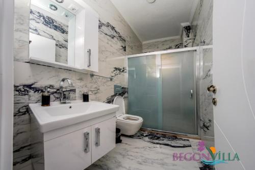 a bathroom with a sink and a toilet at BegonVilla Fethiye-Göcek in Muğla