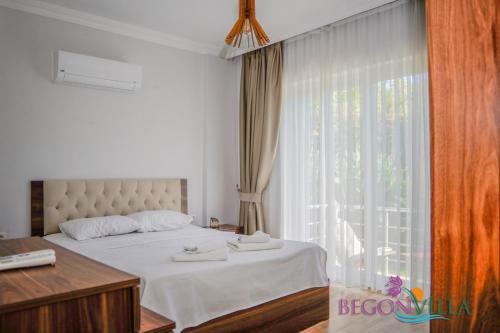 a bedroom with a bed and a large window at Begonvilla 2 in Muğla