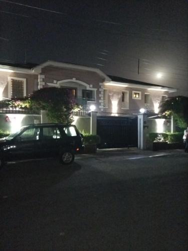 a car parked in front of a house at night at ERiTH APARTMENT & SUITES in Ikeja