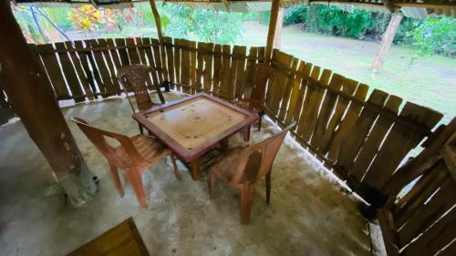 an overhead view of a wooden table and chairs on a porch at Thambapanni safari hostel in Moragaswewa
