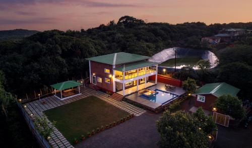an aerial view of a house with a pool at Malibu Villa by Hill Staytion in Panchgani